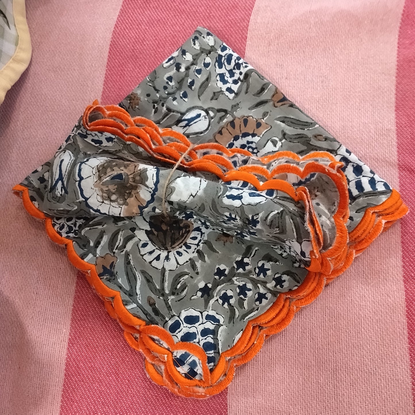 Grey floral napkins with orange trim (pair)