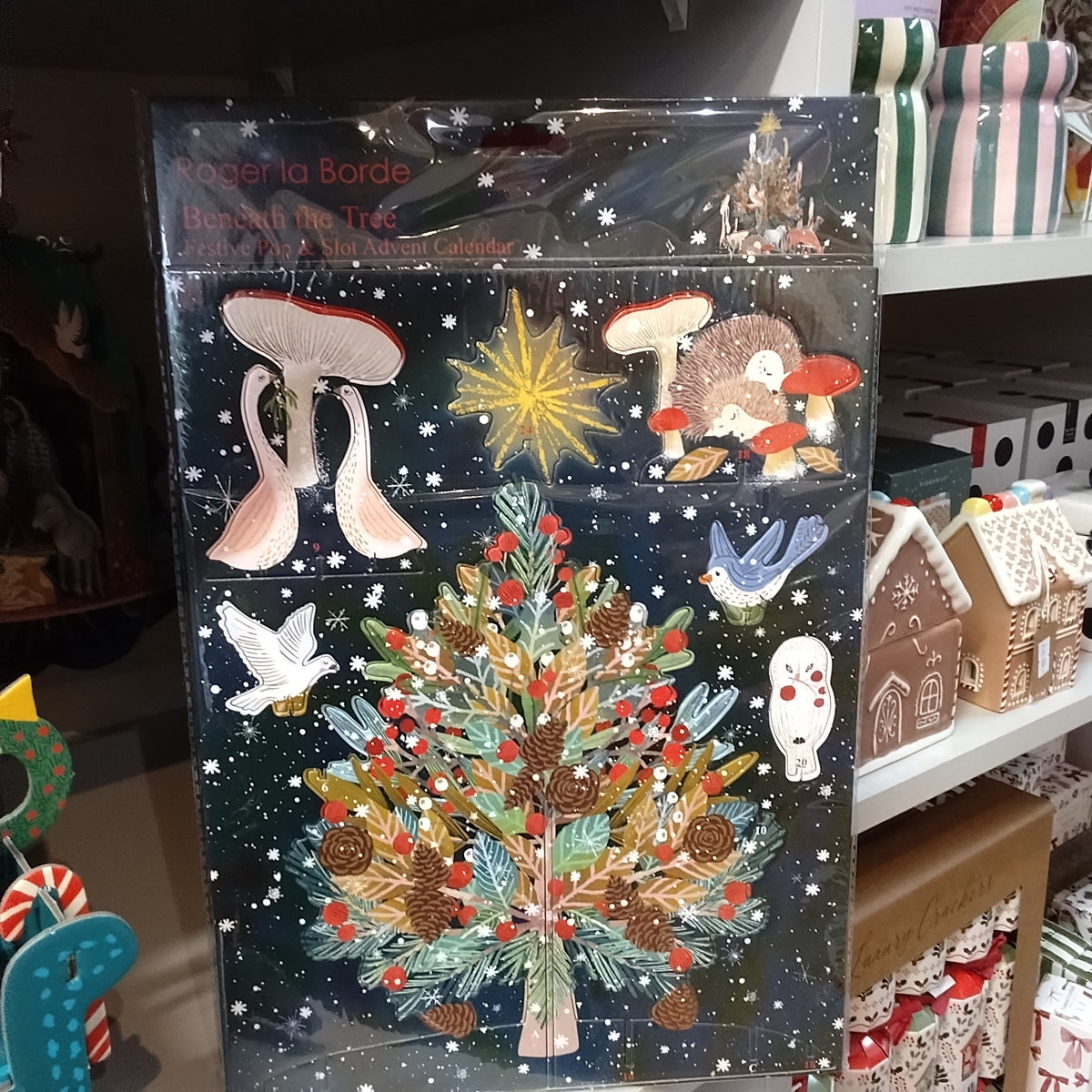 Pop and slot advent calendar . Beneath the tree Christmas theme.