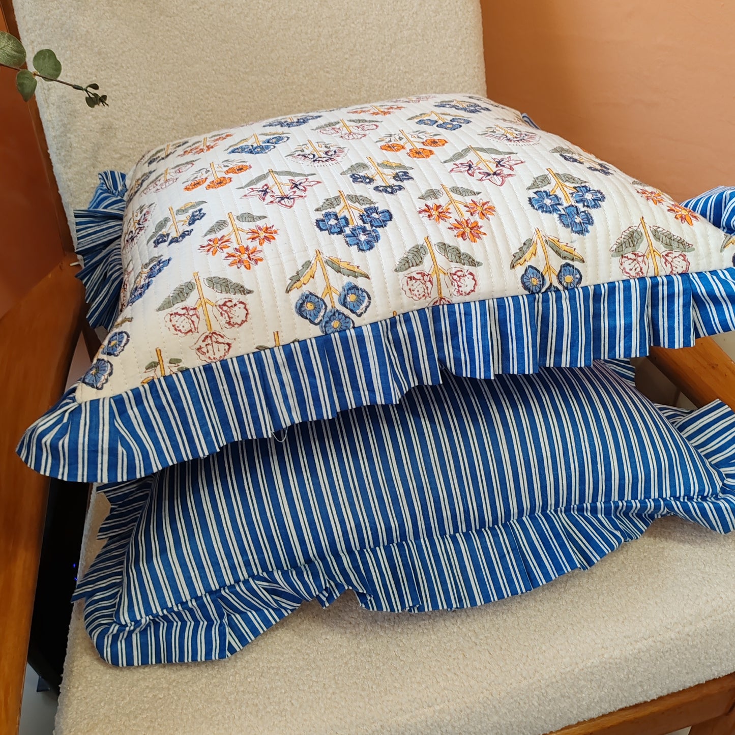 Large white / multi coloured floral cushion cover will a blue white striped frill