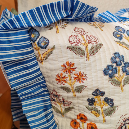 Large white / multi coloured floral cushion cover will a blue white striped frill