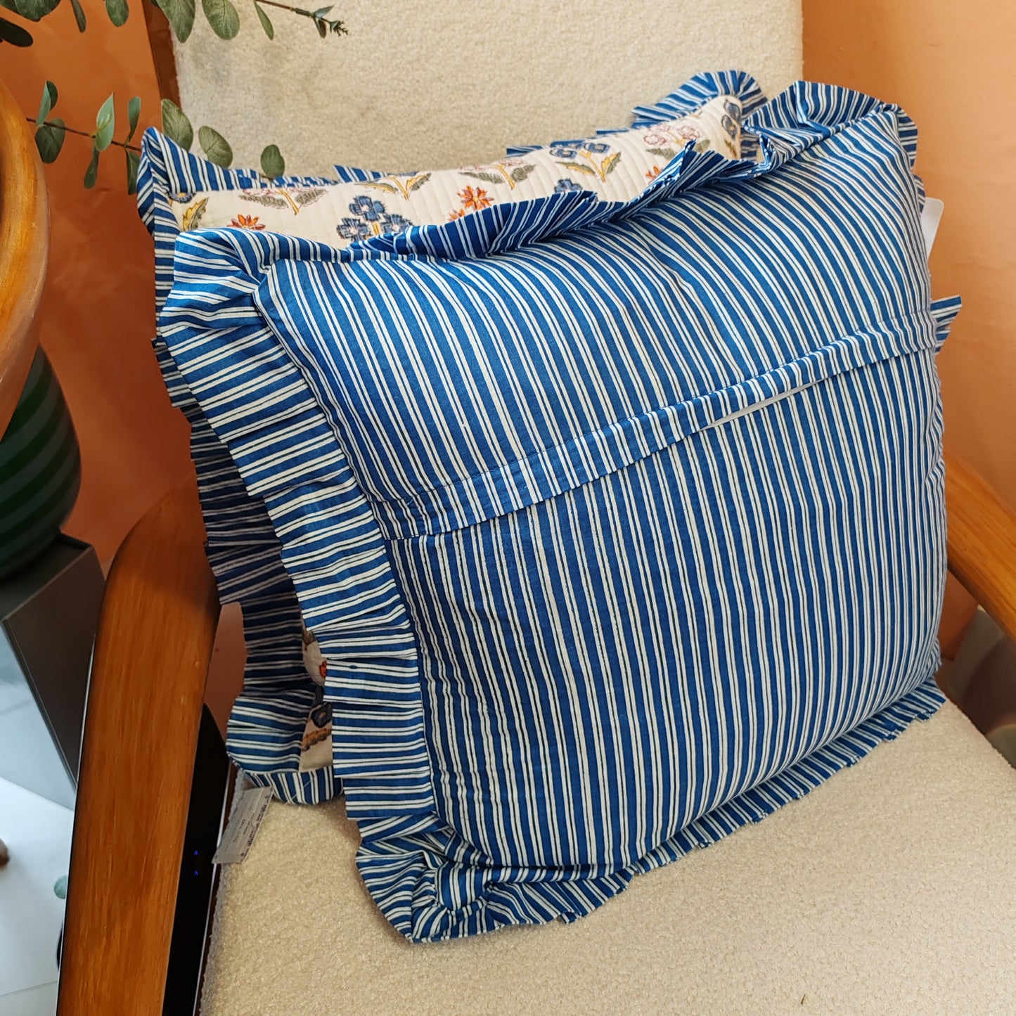 Large white / multi coloured floral cushion cover will a blue white striped frill