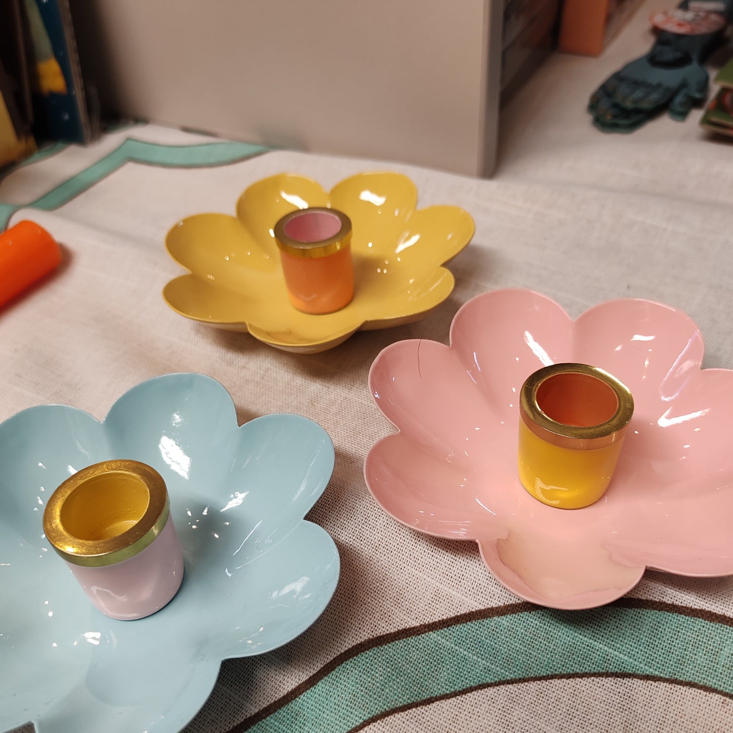 Enamel metal flower candle holder.
