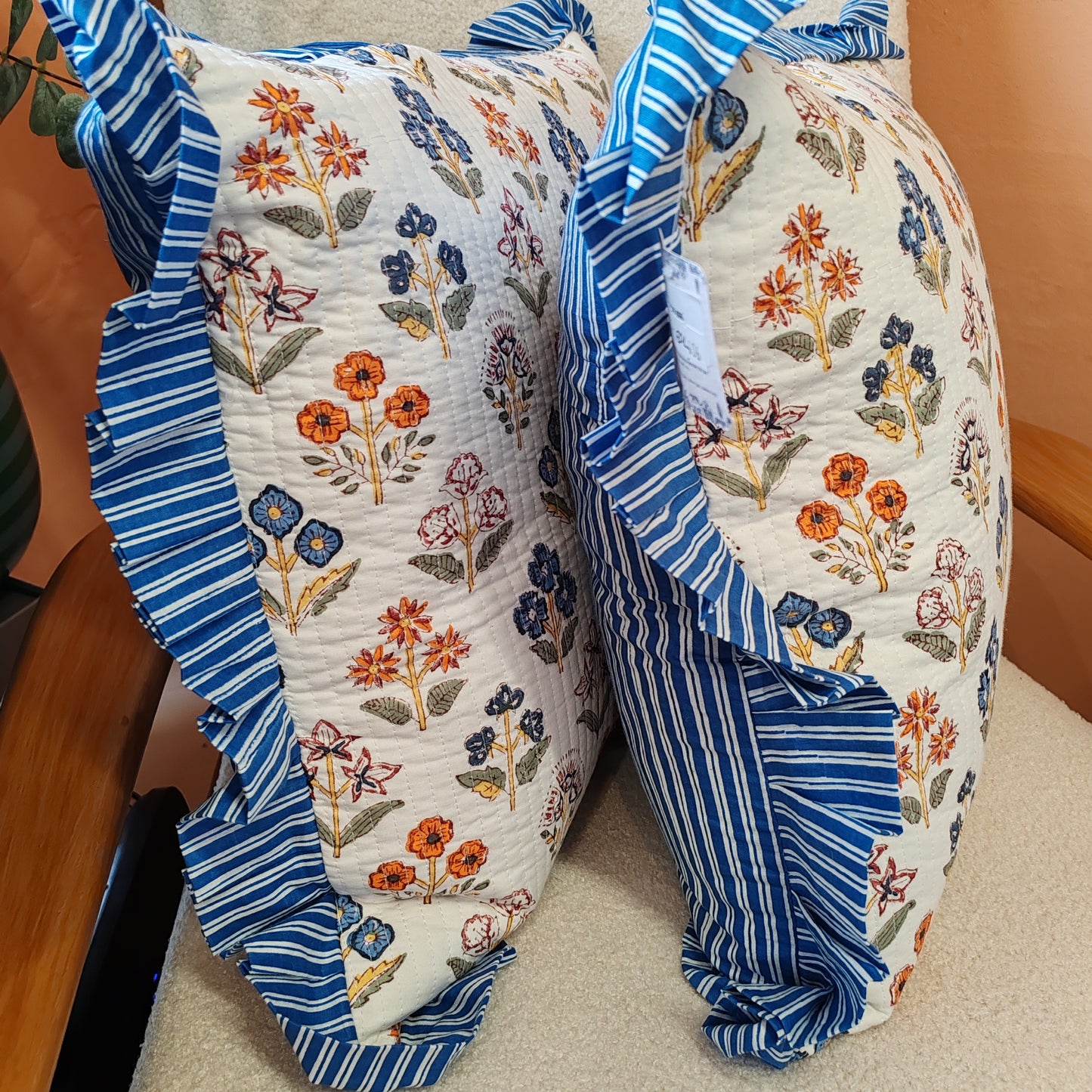 Large white / multi coloured floral cushion cover will a blue white striped frill