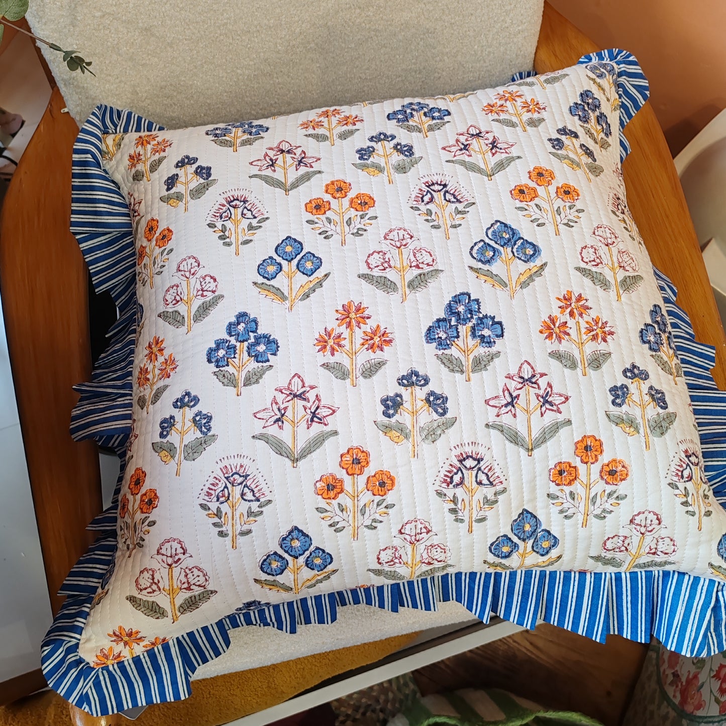 Large white / multi coloured floral cushion cover will a blue white striped frill