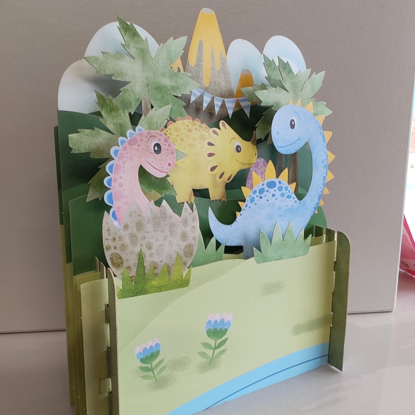 Miniature world 3D pop up greeting card. Dinosaur theme.